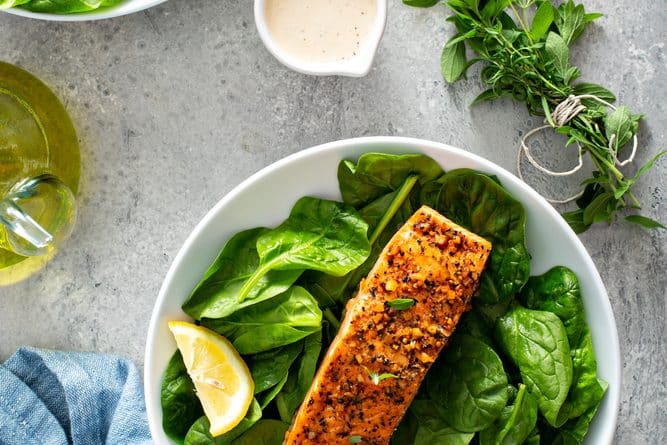 Cedar,Plank,Grilled,Salmon,With,Spinach,And,Spicy,Cream,Sauce